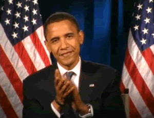 Barack-Obama-Clapping-in-Front-of-American-Flags
