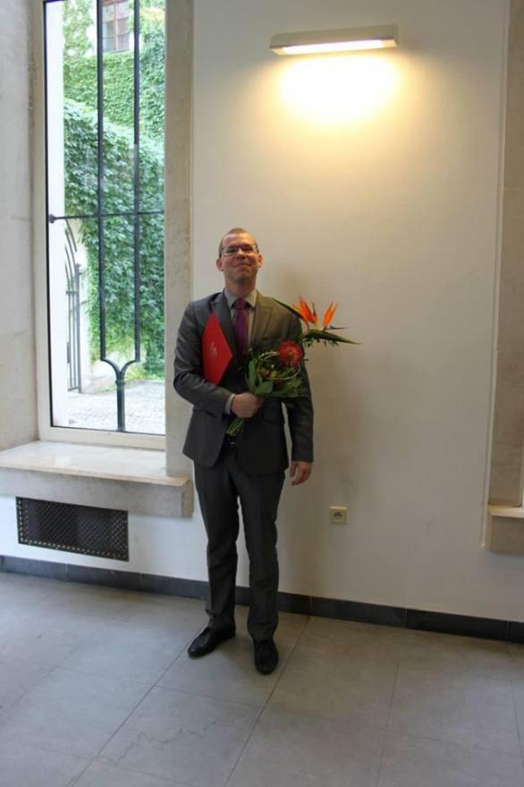 Touto fotkou Kocourek dokazuje, že má červený diplom z Právnické fakulty Univerzity Karlovy. Ze školy byl ale ve skutečnosti vyhozen a diplomy jako na fotce Univerzita Karlova vůbec nevydává.
